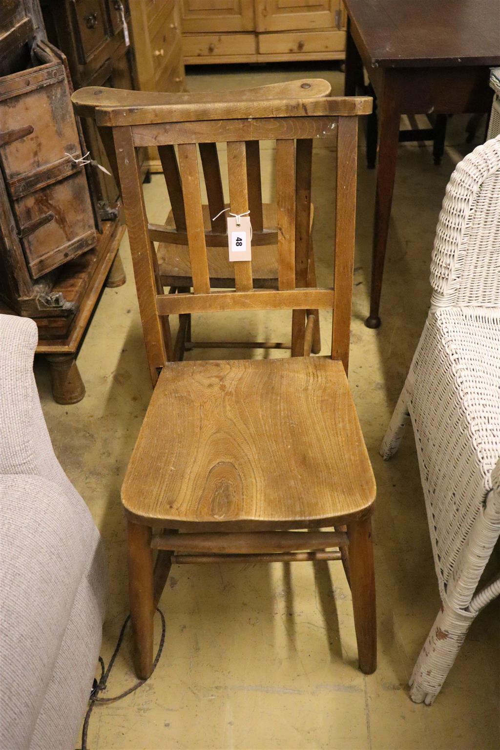 A set of four elm and beech provincial dining chairs